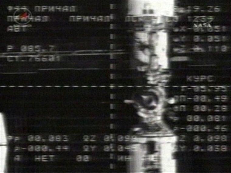 An external camera on Russia's Soyuz TMA-18 spacecraft shows the International Space Station's docking port almost dead ahead during the Soyuz's approach on Sunday.